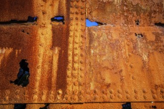 The rough texture of heavily corroded iron plates on the hull of. derelict ship. British Columbia,