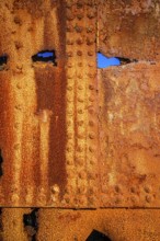 The rough texture of heavily corroded iron plates on the hull of. derelict ship. British Columbia,