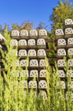 Many stacked concrete blocks with plants in the foreground, Hermann Hessebahn construction site,