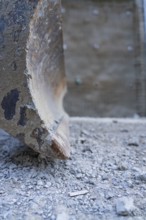 Close-up of a worn shovel on ballast in a construction site environment, Hermann Hessebahn
