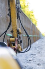 Close-up of a construction machine with hoses on a construction wall, Hermann Hessebahn