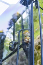 Toy figure with helmet behind a glass pane with nature in the background, Hermann Hessebahn