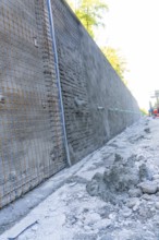 Construction site with a long concrete wall reinforced by wire mesh, Hermann Hessebahn construction