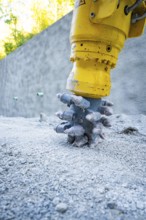 Construction machine drilling into concrete on a building site, Hermann Hessebahn building site,