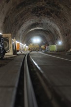 Rail construction in the tunnel with machines and equipment placed on the sides, construction of