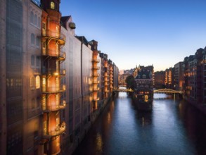 Evening view of the Hamburg warehouse district with a view of the moated castle from