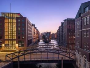 Evening shot of Hamburg's Speicherstadt warehouse district with a view of the moated castle and the