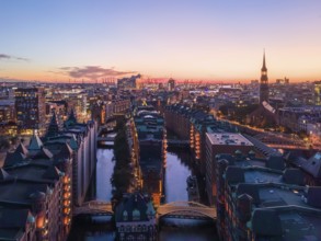 Aerial view of Hamburg's Speicherstadt warehouse district at sunset with a view of the moated