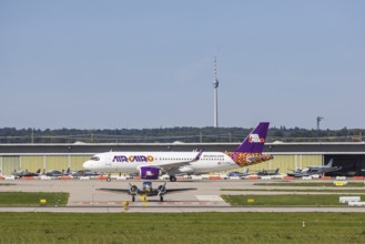 Stuttgart Airport with television tower and aeroplane on the runway. Aircraft registration: SU-BVN,