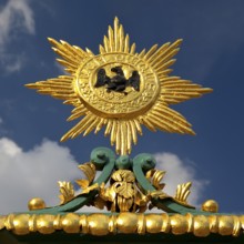 Golden star with black eagle and the Latin inscription suum cuique, to each his own, detail on the