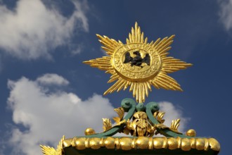 Golden star with black eagle and the Latin inscription suum cuique, to each his own, detail on the