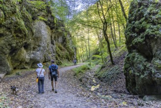Trailfinger Gorge near Seeburg in the Swabian Alb. Man and woman with dog on a hike through the