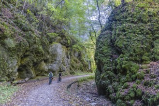 Trailfinger Gorge near Seeburg in the Swabian Alb. Two cyclists on a tour through the romantic