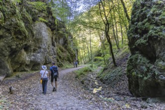 Trailfinger Gorge near Seeburg in the Swabian Alb. Man and woman with dog on a hike through the