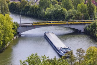Neckar bridge in Stuttgart with SSB tram. The 105 metre long cargo ship ANNABELL on its way to the