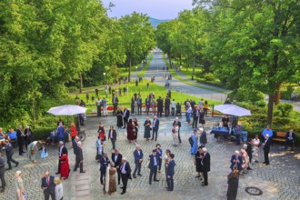 Forecourt of the festival theatre on the Green Hill with festival guests and the driveway avenue,