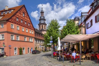 Half-timbered house with street café and hospital church in the old town, beer town Kulmbach,