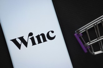 Dhaka, Bangladesh- 03 July 2025: A smartphone displaying the Winc logo next to a miniature shopping