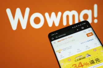 Dhaka, Bangladesh- 03 July 2025: Smartphone displaying wowma web interface against wowma logo