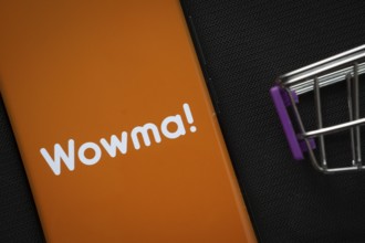 Dhaka, Bangladesh- 03 July 2025: A smartphone displaying the Wowma logo next to a miniature