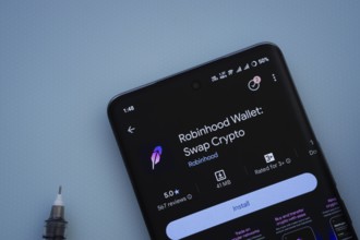 Dhaka, Bangladesh- 29 May 2025: On a blue surface, a smartphone displays the Robinhood Wallet app