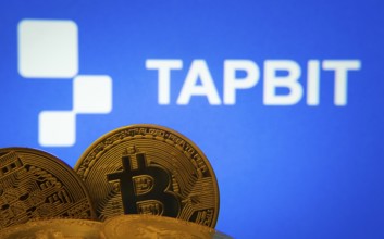 Dhaka, Bangladesh- 20 Sep 2025: Close-up of Bitcoin coins with thex Tapbit logo visible on a screen