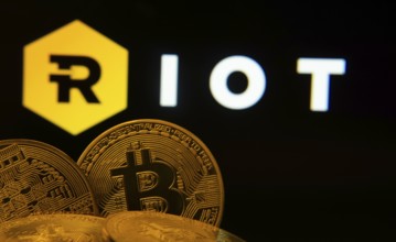 Dhaka, Bangladesh- 20 Sep 2025: Close-up of Bitcoin coins with the Riot Platforms logo visible on a