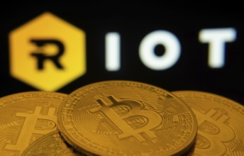 Dhaka, Bangladesh- 20 Sep 2025: Close-up of Bitcoin coins with the Riot Platforms logo visible on a