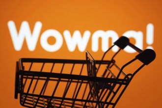 Dhaka, Bangladesh- 03 July 2025: Silhouette of a shopping cart in front of the wowma logo,