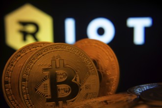 Dhaka, Bangladesh- 20 Sep 2025: Close-up of Bitcoin coins with the Riot Platforms logo visible on a