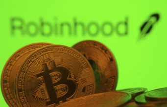 Dhaka, Bangladesh- 20 Sep 2025: Close-up of Bitcoin coins with the Robinhood Markets logo visible