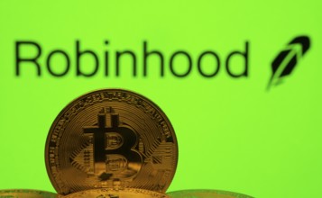 Dhaka, Bangladesh- 20 Sep 2025: Close-up of Bitcoin coins with the Robinhood logo visible on a