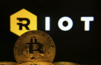 Dhaka, Bangladesh- 20 Sep 2025: Close-up of Bitcoin coins with the Riot Platforms logo visible on a