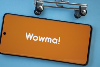 Dhaka, Bangladesh- 03 July 2025: Smartphone screen showing the wowma logo with shopping cart wheels
