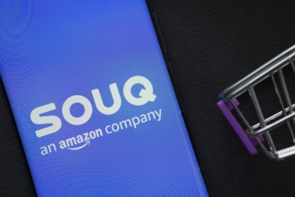 Dhaka, Bangladesh- 03 July 2025: A smartphone displaying the Souq logo next to a miniature shopping