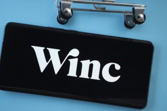 Dhaka, Bangladesh- 03 July 2025: Smartphone screen showing the Winc logo with shopping cart wheels