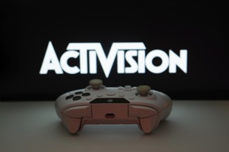 Dhaka, Bangladesh- 23 Sep 2025: A close-up of a white gamepad with the Activision seen on screen in