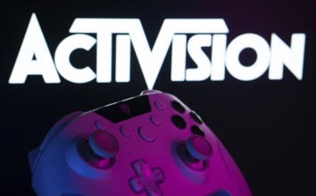 Dhaka, Bangladesh- 23 Sep 2025: A close-up of a white gamepad with the Activision seen on screen in