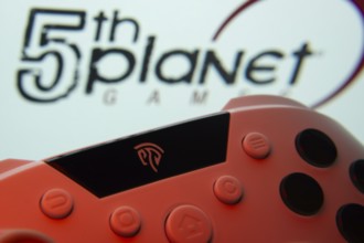 Dhaka, Bangladesh- 23 Sep 2025: A close-up of a gamepad with the 5th planet games seen on screen in
