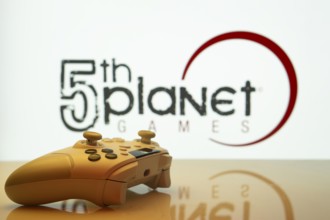 Dhaka, Bangladesh- 23 Sep 2025: Game controller in front of 5th planet games logo on a background