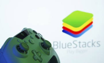 Dhaka, Bangladesh- 23 Sep 2025: A close-up of a gamepad with the BlueStacks seen on screen in the