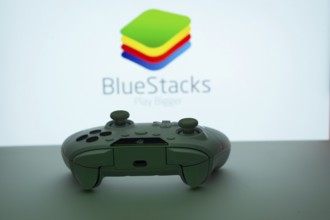 Dhaka, Bangladesh- 23 Sep 2025: Game controller in front of BlueStacks logo on a background
