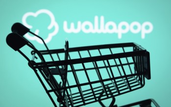 Dhaka, Bangladesh- 03 July 2025: Silhouette of a shopping cart in front of the Wallapop logo,