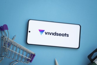 Dhaka, Bangladesh- 03 July 2025: Smartphone displaying VividSeats logo with shopping cart on a blue