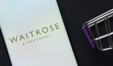 Dhaka, Bangladesh- 03 July 2025: A smartphone displaying the Waitrose & Partners logo next to a