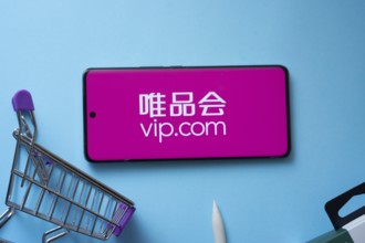 Dhaka, Bangladesh- 03 July 2025: Smartphone displaying vip.com logo with shopping cart on a blue