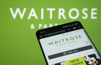 Dhaka, Bangladesh- 03 July 2025: Smartphone displaying Waitrose & Partners web interface against (.