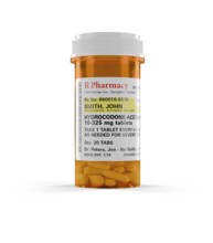 Hydrocodone prescription medicine bottle and pills isolated on a white background. the label is