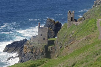 Historic ruins perched on a cliff, surrounded by rocky coastline and surging sea waves, engine room