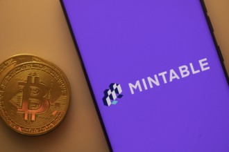 A Bitcoin and Mintable logo on a full purple background